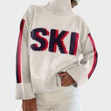 Pull col roulé crème avec inscription SKI bleu marine et rouge — Brigitte, LucieSaint-Tropez